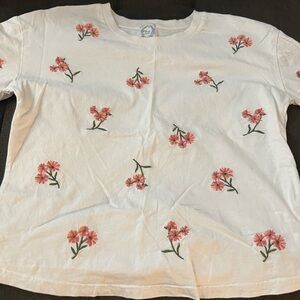 Small white t shirt. Cropped fit with embroidered flowers only on the front.